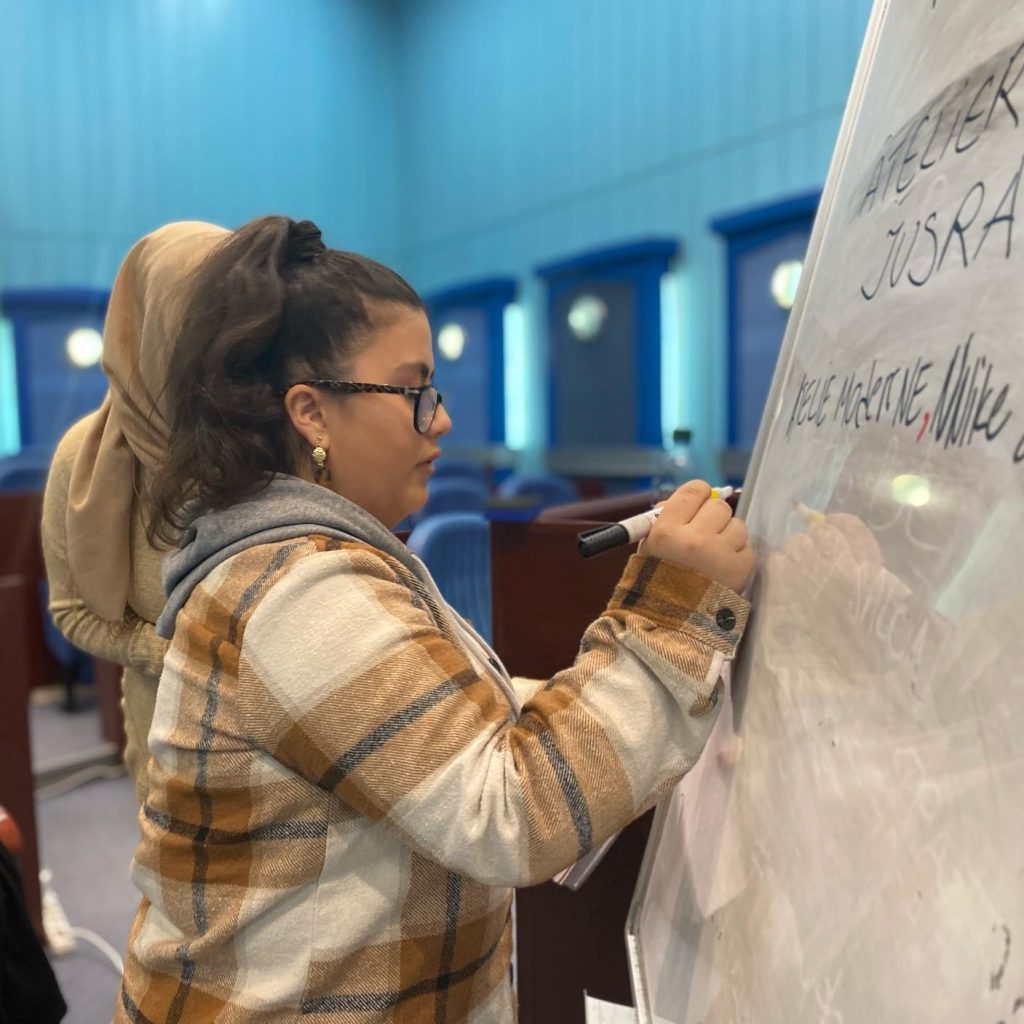 Training für arbeitslose Frauen, Frau schreibt auf Flipchart